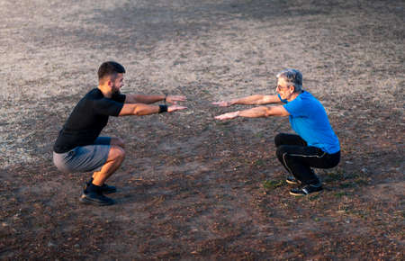 Men stretching before a workout outdoors, healthy lifestyleの写真素材