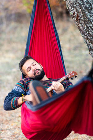 Man relaxing in a hammock on a hiking tripの写真素材