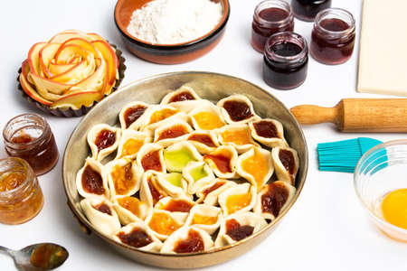 Homemade sweet pie with various fruit jams top view