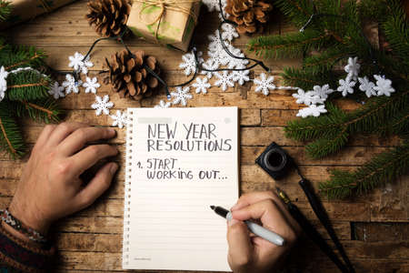 Man writing start working out new year resolutionの写真素材
