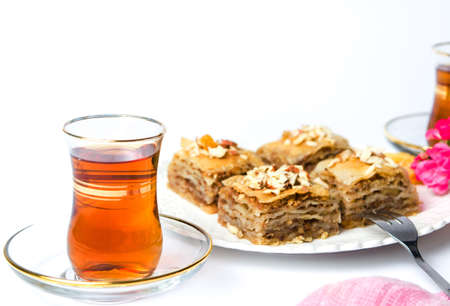 Baklava dessert slices with nuts on white background