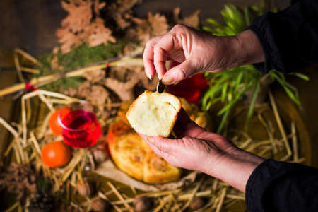 Person finding coin in Orthodox Christmas eve breadの写真素材