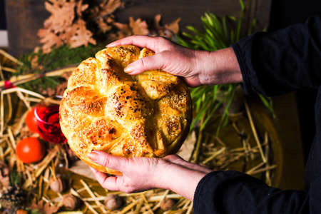 Woman holding Orthodox Christmas eve bread closeup