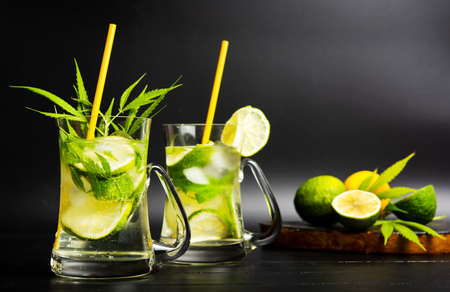 Lime cocktail with marijuana in a glass on dark backgroundの写真素材
