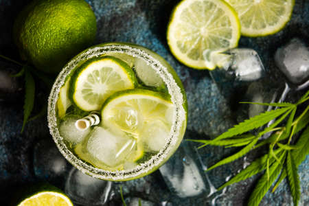 Lime cocktails with marijuana on stone table top viewの写真素材