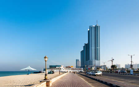 Ajman, United Arab Emirates - December 6, 2018: Ajman Corniche Beach beautiful coast in the city downtown area surrounded by high residential buildingsのeditorial素材