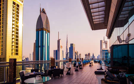 Dubai, United Arab Emirates - April 3, 2018: Modern skyscrapers of downtown Dubai from a rooftop coffee bar at sunset, modern architecture of UAEのeditorial素材