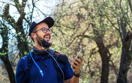 Cheerful man on a hiking trip enjoying time outdoors, healthy lifestyle abstract