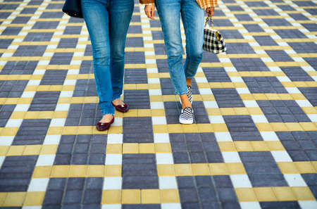 Fashionable girls walking on the street closeupの写真素材