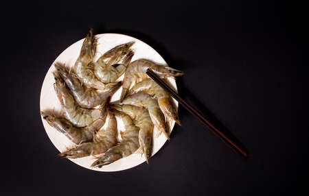 Raw shrimps on a plate flat lay top viewの写真素材