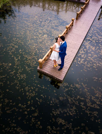 Romantic couple kissing in the park by the lakeの写真素材