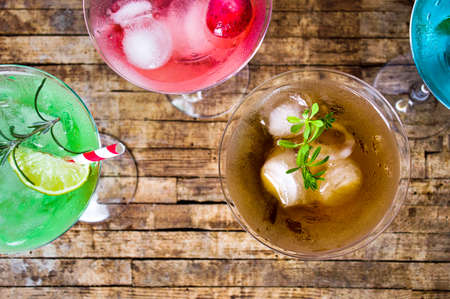 Colorful cocktails on a wooden table top viewの写真素材