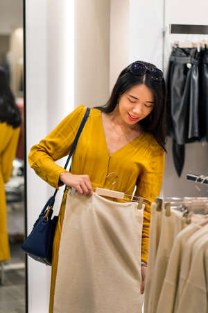 Girl trying new clothes in the boutiqueの写真素材
