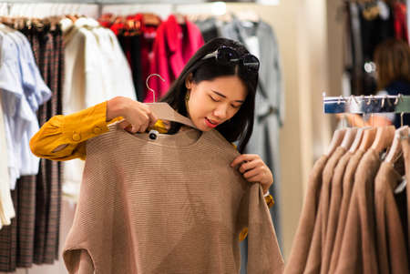 Girl trying new clothes in the boutiqueの写真素材