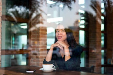 Girl having a cup of coffee in the barの写真素材