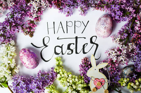 Happy Easter card with spring flowers and painted eggsの写真素材