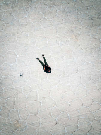 Guy flying a drone in the salt flats of Boliviaの写真素材