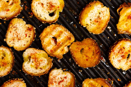 Slices of bread on a grill for home made bruschettaの写真素材