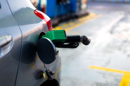 Nozzle in the car for adding petrol close upの写真素材