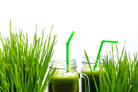 Wheat grass and smoothies isolated on white backgroundの写真素材