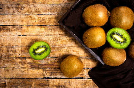 Kiwi fruits on a rustic wooden table top viewの写真素材