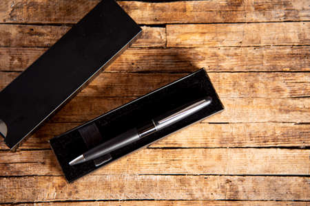Black pen on a wooden table top viewの写真素材