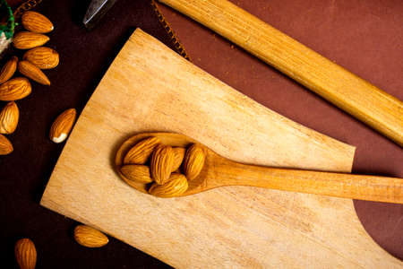 Bunch of almonds and a hammer on a tableの写真素材