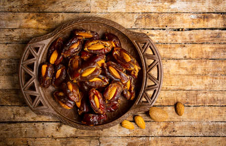 Fresh date fruits with almonds on a table