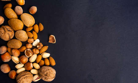 Various nuts on a pile top view, healthy foodの写真素材