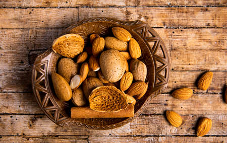 Almonds and cinnamon in a bowl top viewの写真素材