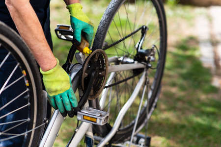 Man lubricating bicycle chain and maintaining for the new seasonの写真素材