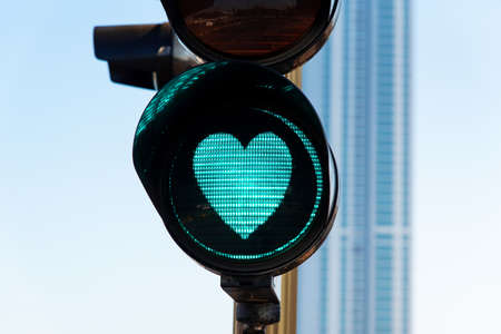 Heart shaped traffic light on the street close up