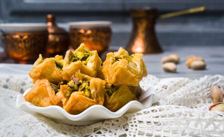 Arabic baklava dessert with coffee in copper cups
