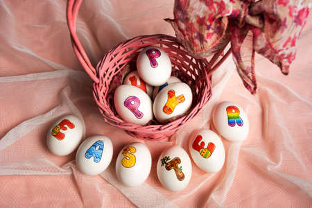 Decorated Easter eggs in a basket top view