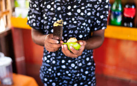Man cutting avocado in a bar close up