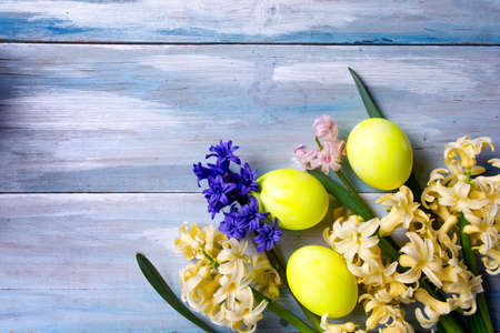 Painted Easter eggs and hyacinth spring flowers top view