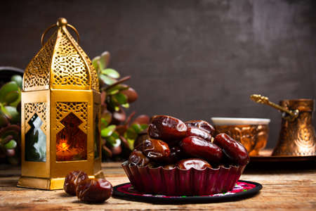 Dates and Arabic style lamp on a table with copy space