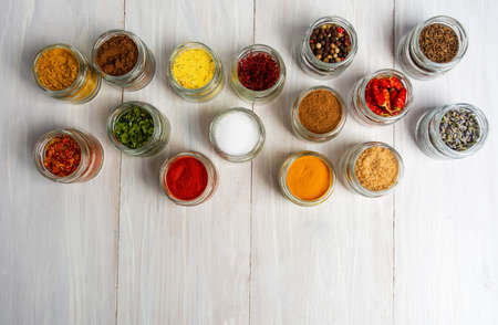 Large collection of spices in small bowls on whiteの写真素材