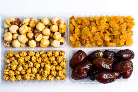 Various nuts and dried fruit arranged serving top view
