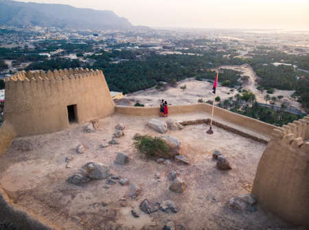 Couple enjoying sunset view from Dhayah fort in Ras Khaimah emirate in UAE aerialのeditorial素材