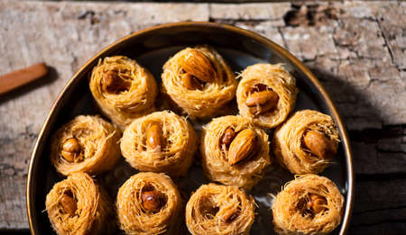 Arabic kadayif baklava dessert with cashew nuts on a plate