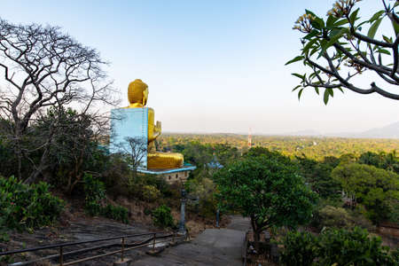 Dambulla, Sri Lanka - March 30, 2019: Golden temple with big Buddha statue near Dambulla cave temple complex in Sri Lankaのeditorial素材