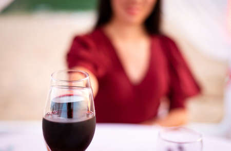 Couple toasting with glass of wine a date closeupの写真素材