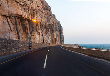 Scenic coastal road in Musandam Governorate of Oman surrounded by sandstones
