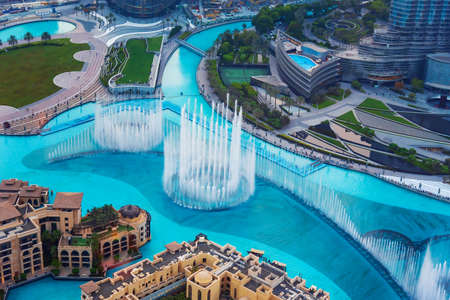 Dubai, United Arab Emirates - July 5, 2019: Dubai mall fountain show surrounded and modern downtown buildings view from above