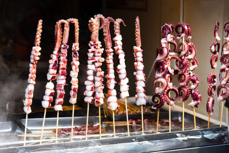 Squid pieces ready food barbequing on the food market in Chinaの写真素材
