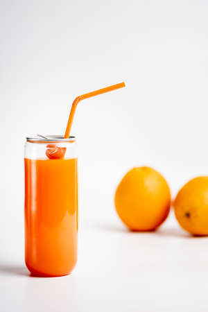 Orange juice in a see-through can on whiteの写真素材
