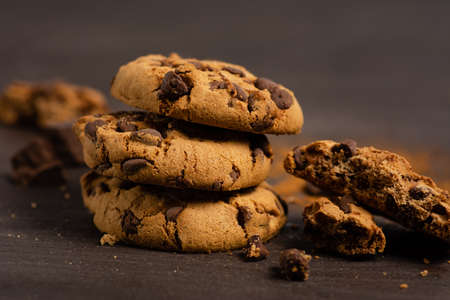 Fresh chocolate chip cookies on a wooden table