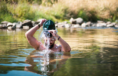 Man cooling down in a river on a hot summer dayの写真素材