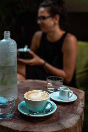 Girl enjoying a cup coffee at a coffee shopの写真素材